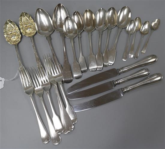 A pair of George III silver berry spoons and a quantity of silver flatware and three silver handled knives, 28.5 oz.